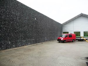Umzäunung Firmengelände - Die ca. 8 Meter hohe Mauer aus Gabionen umgibt ein Firmengelände - 